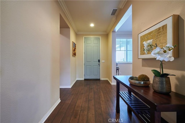 entryway with dark wood-style floors, crown molding, recessed lighting, visible vents, and baseboards