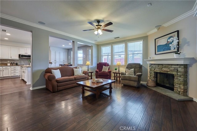 living room featuring dark wood-style floors, a fireplace, crown molding, and baseboards