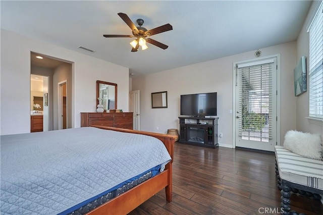 bedroom with dark wood-type flooring, a fireplace, visible vents, baseboards, and access to exterior