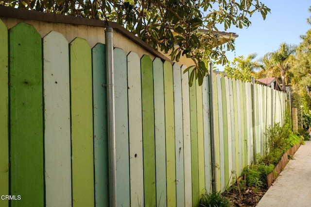 view of outbuilding featuring fence