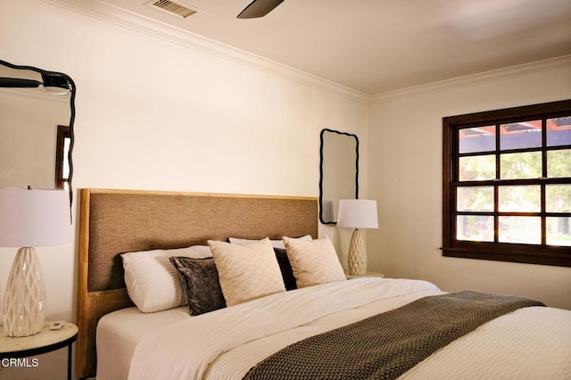 bedroom with ornamental molding, visible vents, and ceiling fan