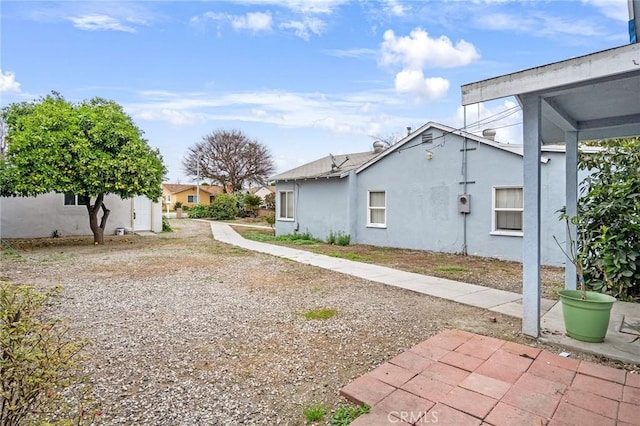 view of side of property featuring stucco siding