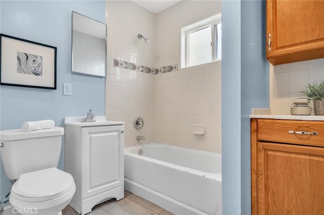 bathroom with toilet, shower / tub combination, and vanity