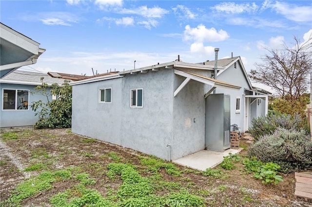 view of side of home with stucco siding