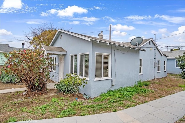 view of side of home with stucco siding