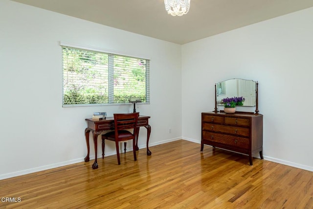 sitting room featuring light wood finished floors and baseboards