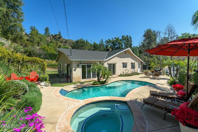 view of swimming pool featuring a fenced in pool, outdoor dining area, a patio, fence, and an in ground hot tub