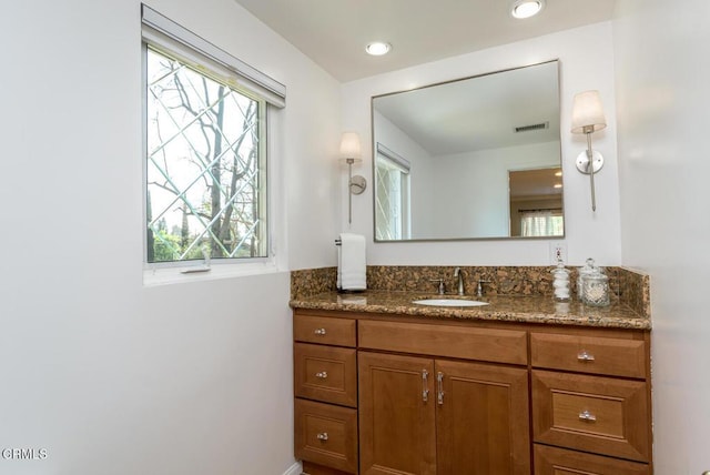 bathroom featuring recessed lighting, plenty of natural light, visible vents, and vanity