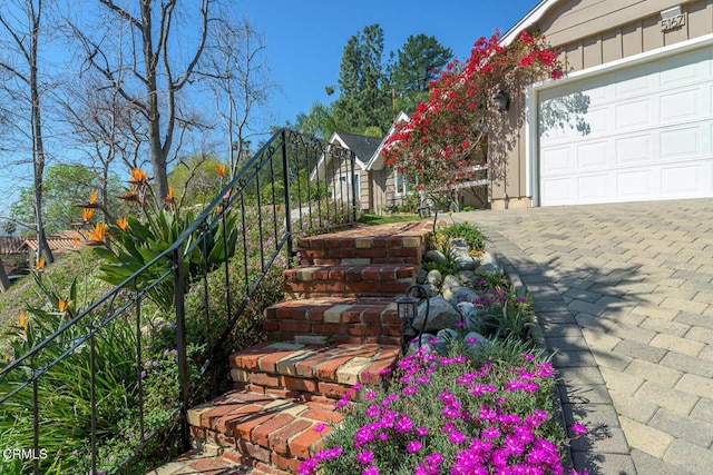 view of yard featuring a garage and fence