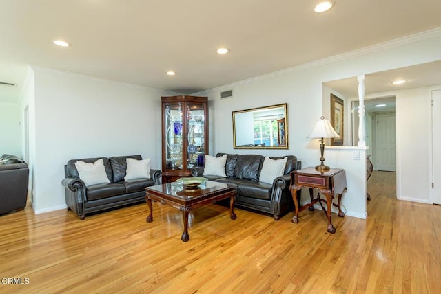 living room with baseboards, visible vents, ornate columns, crown molding, and light wood-style floors