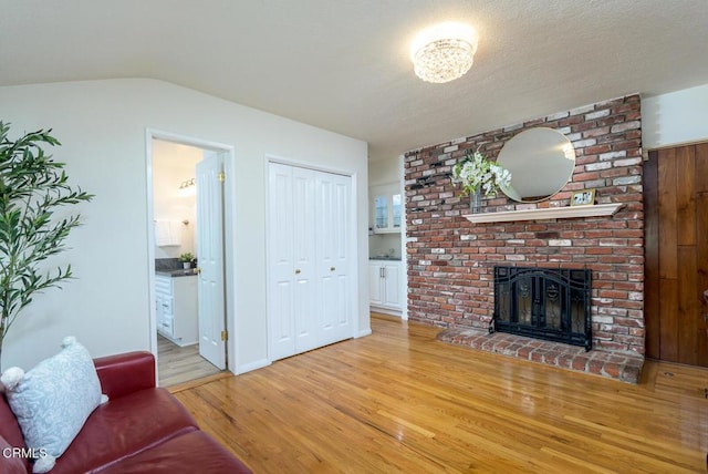 living area featuring a fireplace and light wood-style flooring