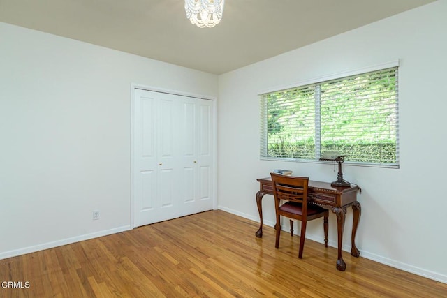 office area with light wood-type flooring and baseboards