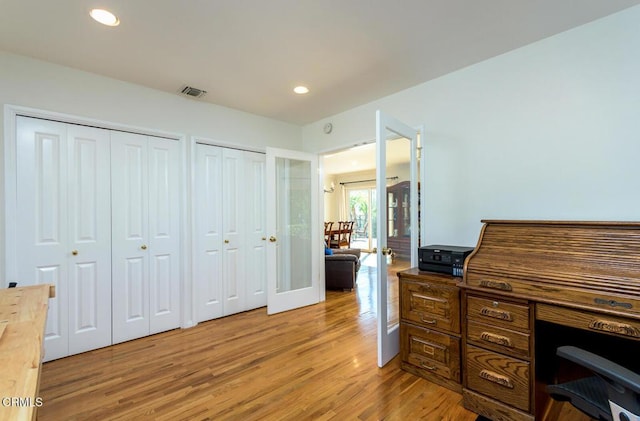 office space featuring light wood finished floors, visible vents, and recessed lighting