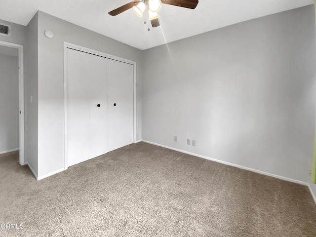 unfurnished bedroom featuring baseboards, a closet, visible vents, and carpet flooring