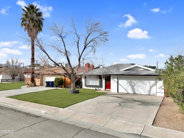 ranch-style home featuring concrete driveway, a front lawn, a chimney, and an attached garage