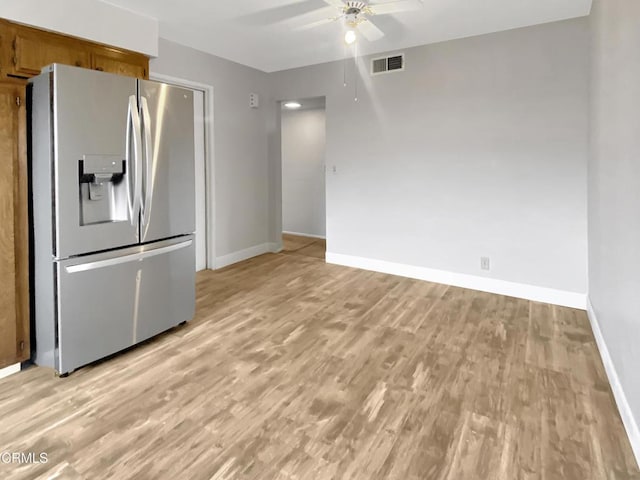 kitchen with light wood finished floors, baseboards, stainless steel fridge with ice dispenser, ceiling fan, and brown cabinets