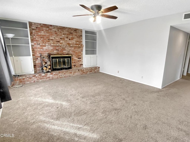 unfurnished living room featuring carpet floors, a brick fireplace, a textured ceiling, and built in features