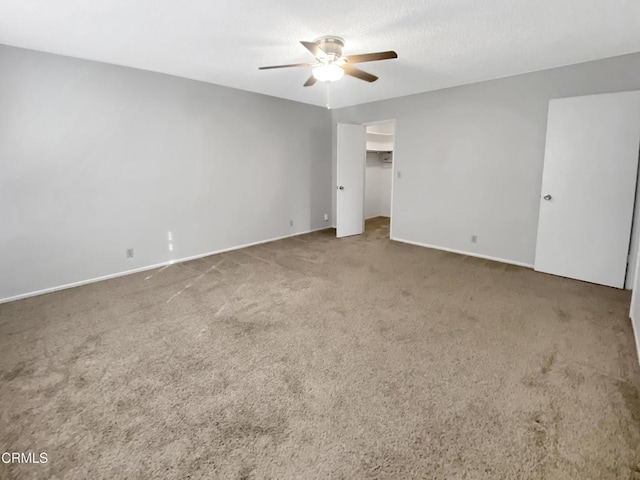 unfurnished bedroom with carpet, ceiling fan, and baseboards