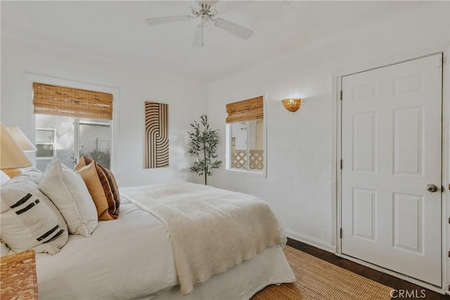 bedroom with baseboards, a ceiling fan, and wood finished floors