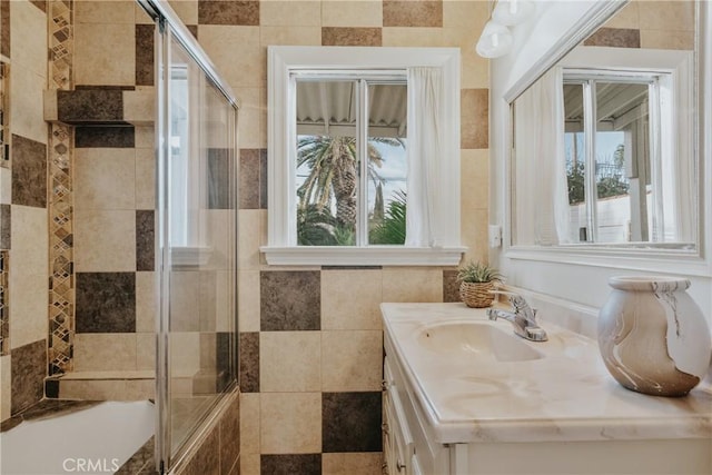 bathroom with a wealth of natural light, a stall shower, and vanity