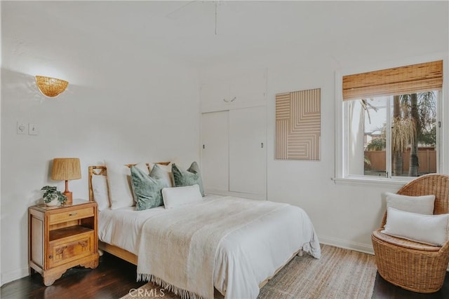 bedroom featuring baseboards and wood finished floors