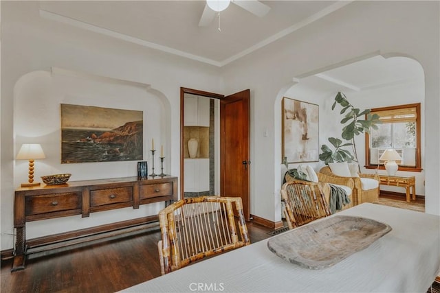 dining area featuring crown molding, wood finished floors, and arched walkways