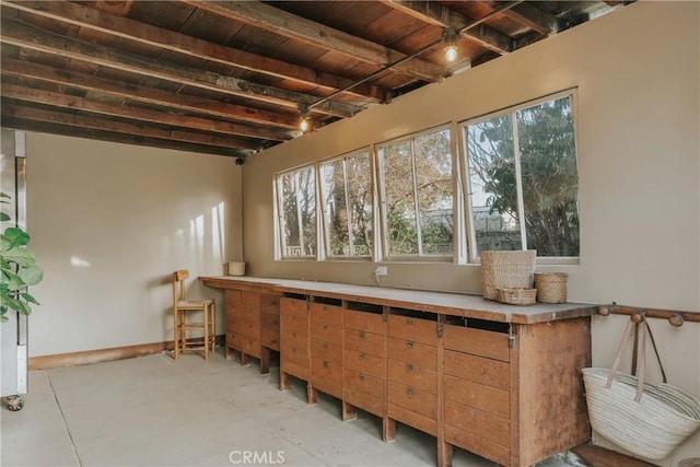 sunroom with beamed ceiling and wooden ceiling