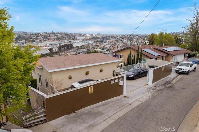 view of front of house featuring fence and stucco siding