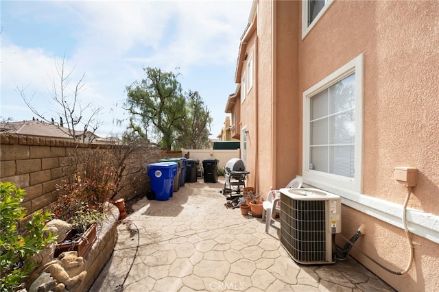 view of patio / terrace featuring a fenced backyard, a grill, and central AC unit