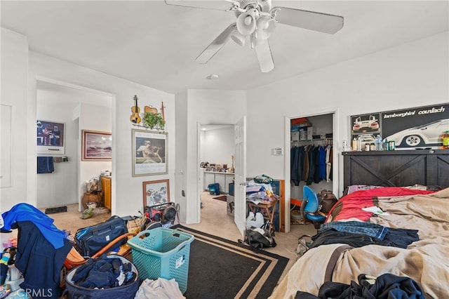 bedroom featuring a ceiling fan, a closet, carpet flooring, and a spacious closet