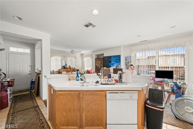 kitchen featuring open floor plan, tile counters, visible vents, and dishwasher