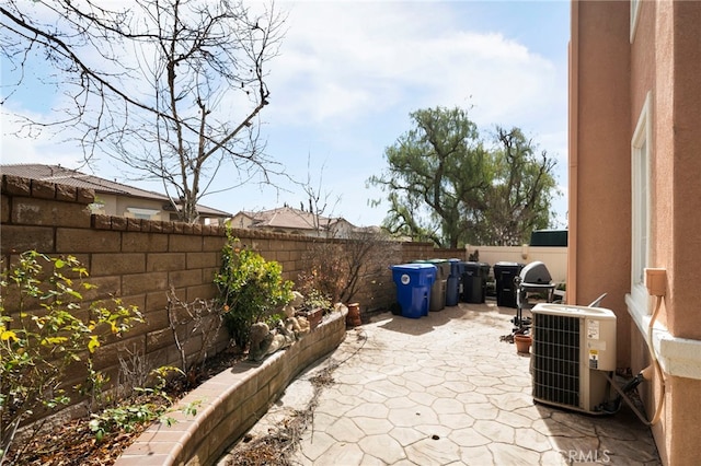 view of patio with central air condition unit and a fenced backyard