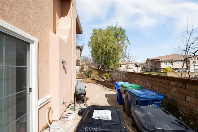 view of patio featuring fence and a residential view