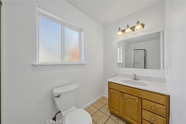 full bathroom featuring toilet, a shower with shower door, vanity, baseboards, and tile patterned floors