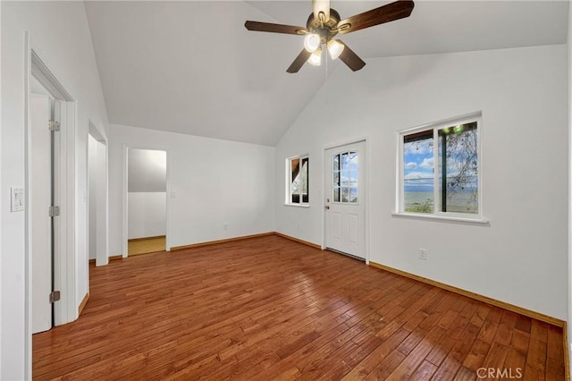 unfurnished bedroom featuring vaulted ceiling, ceiling fan, wood-type flooring, and baseboards