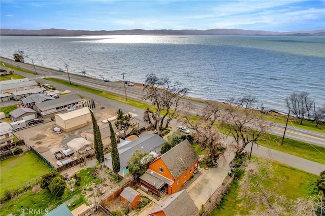 drone / aerial view with a water and mountain view