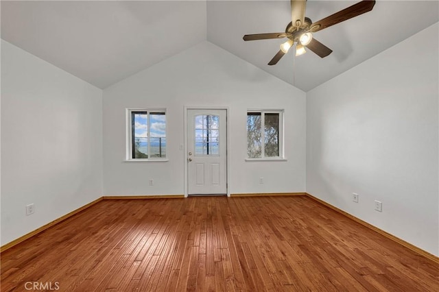 interior space with lofted ceiling, ceiling fan, baseboards, and hardwood / wood-style flooring