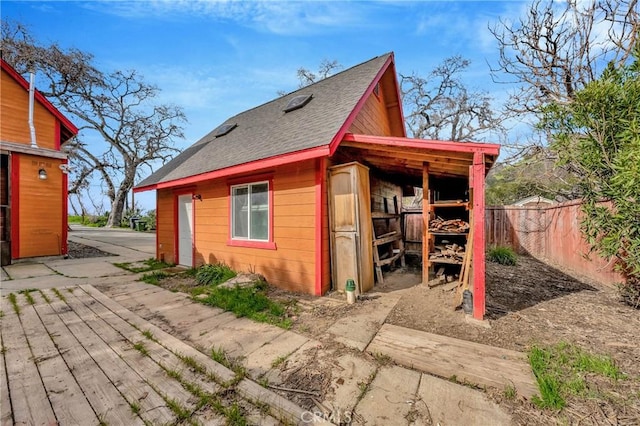 view of outbuilding with an outbuilding and fence