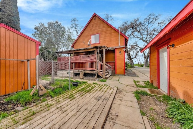 back of house with a deck