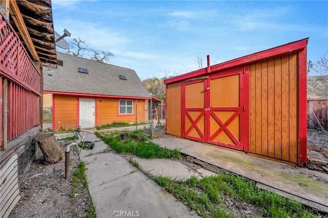 view of shed featuring fence