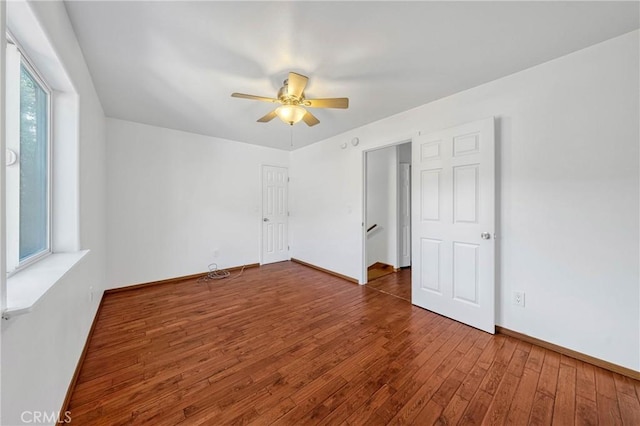 unfurnished bedroom with wood-type flooring, baseboards, and ceiling fan