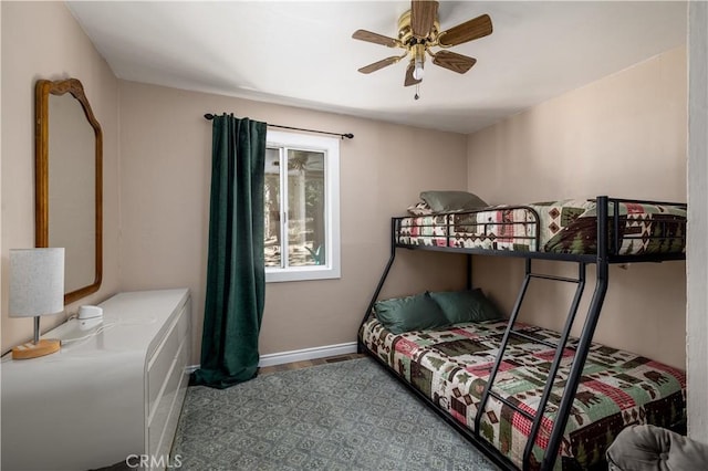 bedroom featuring ceiling fan and baseboards