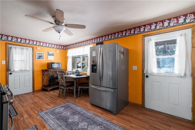 kitchen with a healthy amount of sunlight, ceiling fan, stainless steel fridge with ice dispenser, and wood finished floors