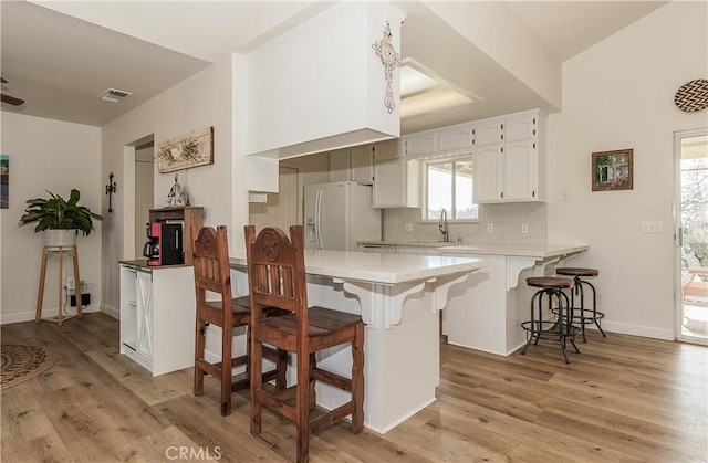 47384 Veater Ranch Rd, Coarsegold, CA 93614 - kitchen with white fridge with ice dispenser, a sink, a peninsula, and light wood finished floors