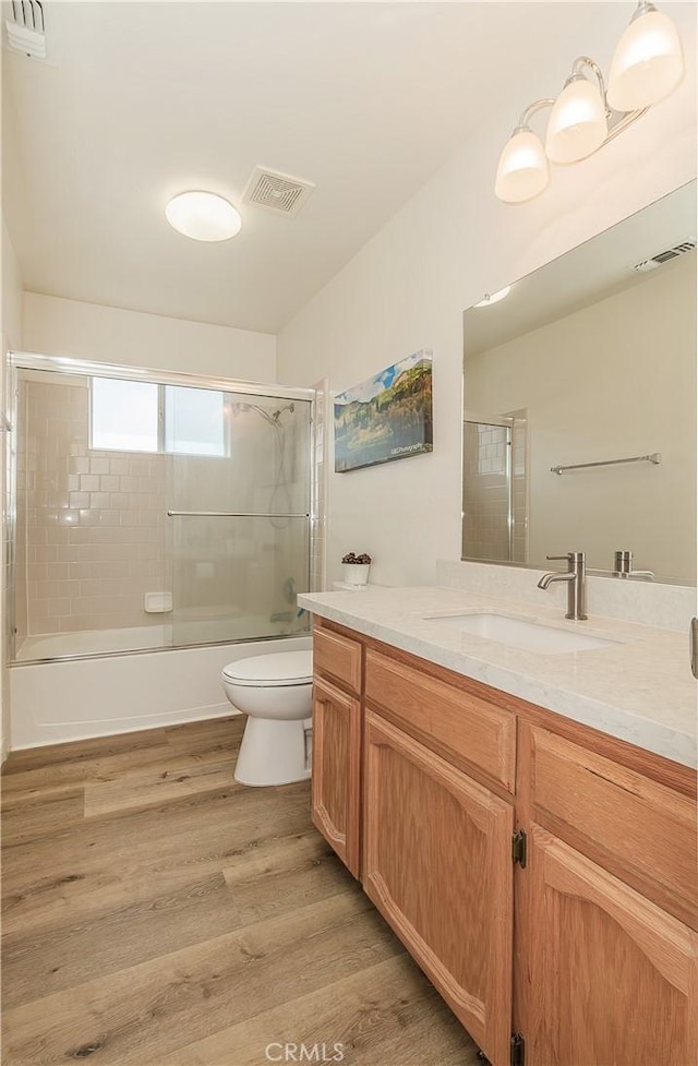 47384 Veater Ranch Rd, Coarsegold, CA 93614 - full bath featuring wood finished floors, toilet, vanity, and bath / shower combo with glass door