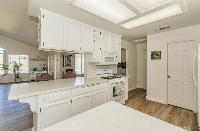47384 Veater Ranch Rd, Coarsegold, CA 93614 - kitchen featuring white appliances, white cabinets, light wood finished floors, light countertops, and a peninsula
