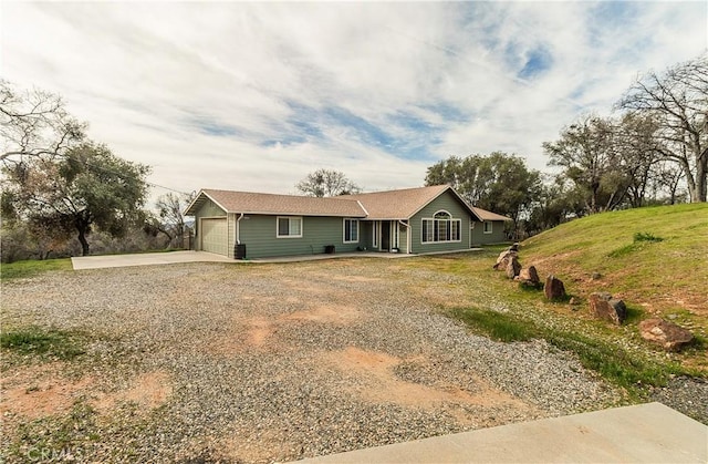 single story home featuring concrete driveway and an attached garage