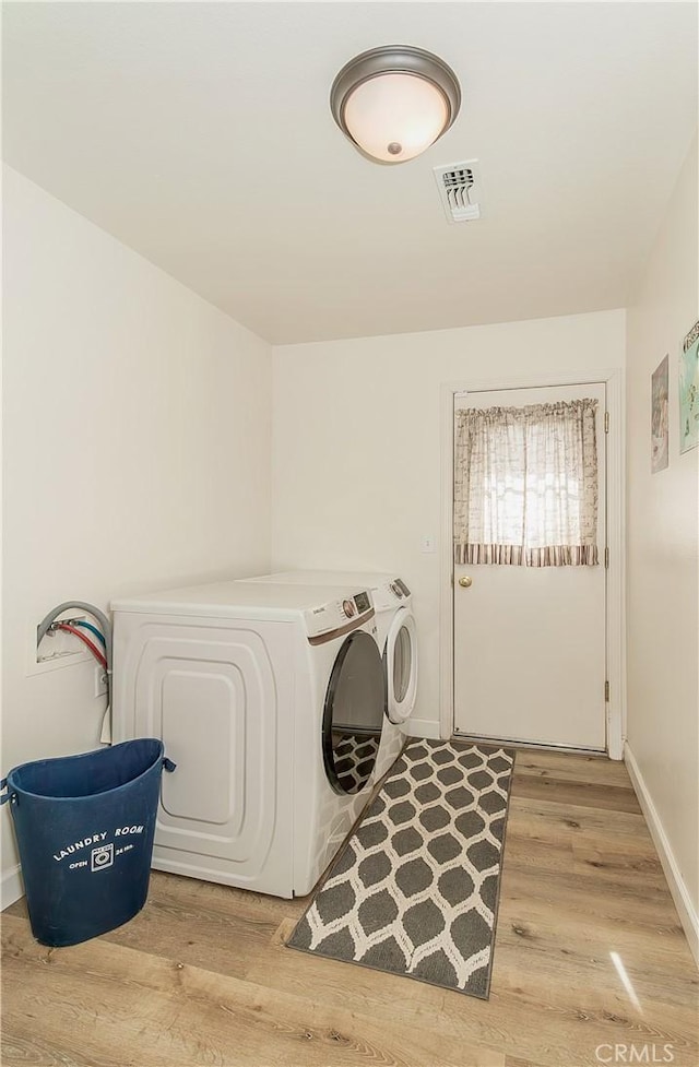 47384 Veater Ranch Rd, Coarsegold, CA 93614 - clothes washing area featuring washing machine and clothes dryer, light wood-style flooring, and baseboards