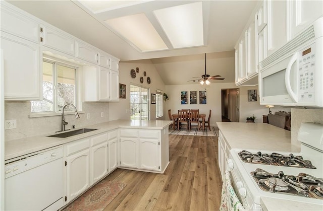 47384 Veater Ranch Rd, Coarsegold, CA 93614 - kitchen with white appliances, a sink, white cabinets, a peninsula, and ceiling fan
