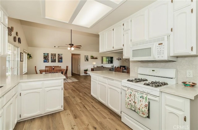 47384 Veater Ranch Rd, Coarsegold, CA 93614 - kitchen with white appliances, a peninsula, ceiling fan, white cabinets, and light wood finished floors